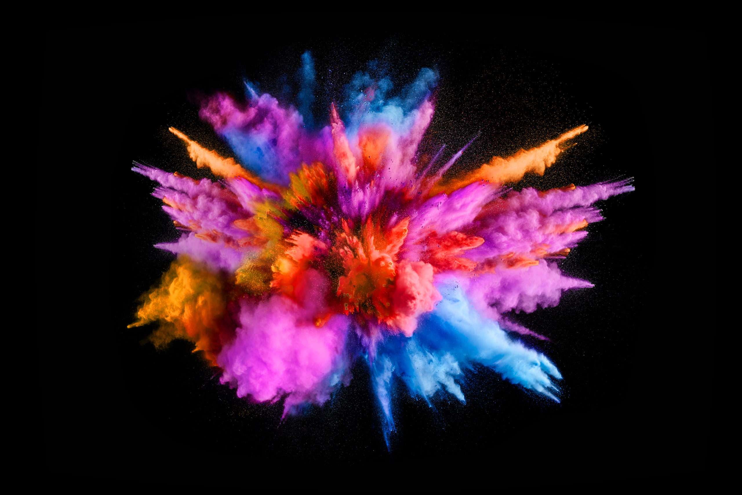 Explosion of colored powder on black background